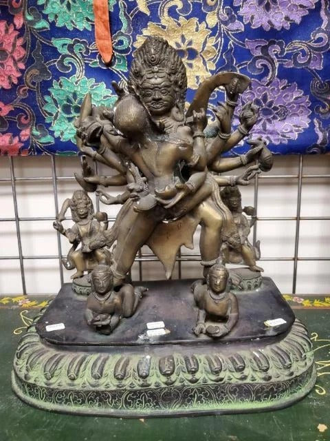 Buddhist Shakti statue displayed on wooden altar platform