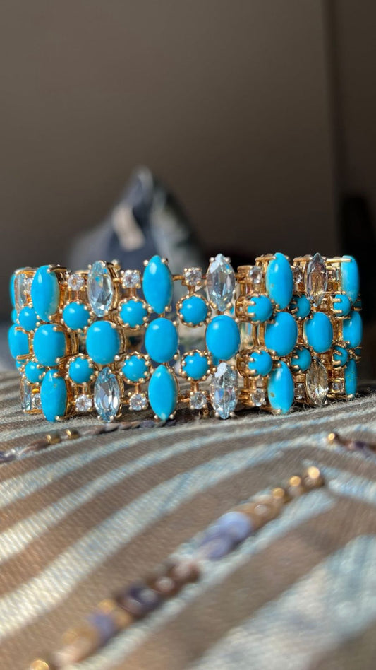 Vibrant sterling silver and gold-tone bracelet featuring brilliant blue-green Persian turquoise and sparkling aquamarine gems, showcasing a bold, vintage-inspired design.