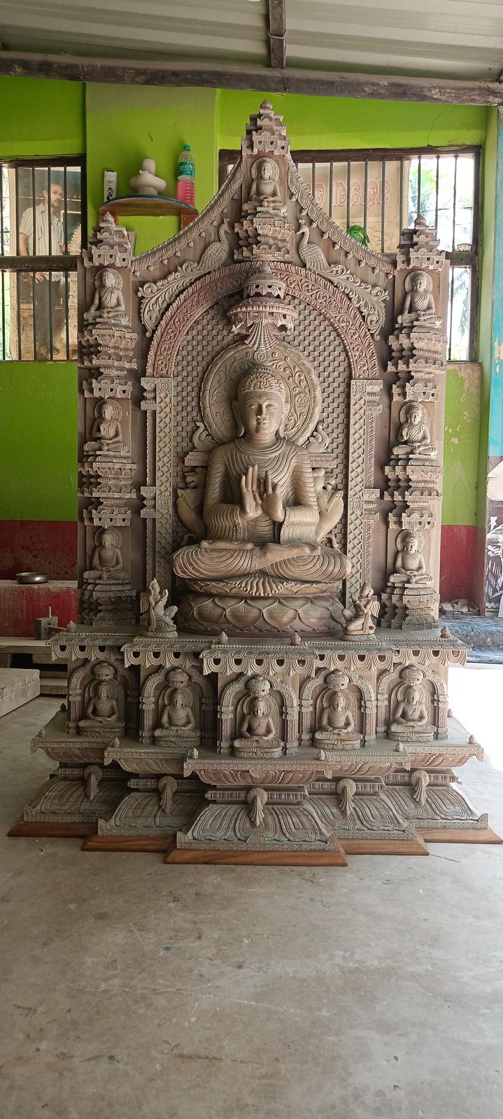 Hand-carved sandstone Buddha statue inspired by Mahabodhi Temple with detailed Bodhisattva carvings