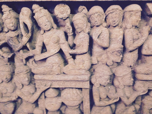 Hand-carved sandstone wall panel with intricate Buddhist prayer motifs and spiritual jali design