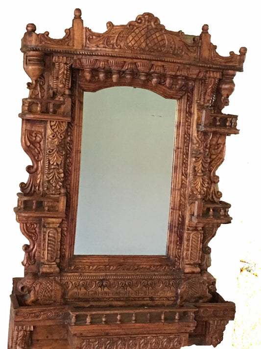 Hand-carved wooden mirror frame with ornate detailing