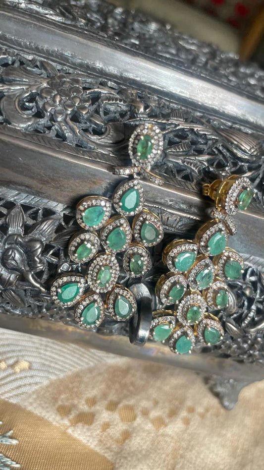 Vintage-style emerald dangle earrings with melee diamonds